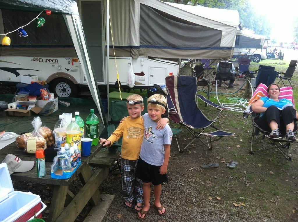 Woman on Lounge Chair and Two Boys Outside Clipper Motorhome Rental